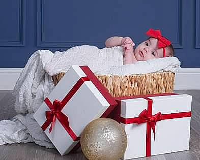 Elianna is registered to the contest to win money with this photo: baby, carmine, child, christmas, christmas_eve, comfort, costume_hat, couch, event, fashion_accessory, fur, hat, headgear, headwear, holiday, interior_design, linens, person, room, santa_claus
