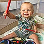 toddler, child, toy, drumsticks, drum_set, playpen, smile, happy, indoor, shorts, tshirt, colorful, floor_mat, baby, hands, legs, face, music, playing, cute