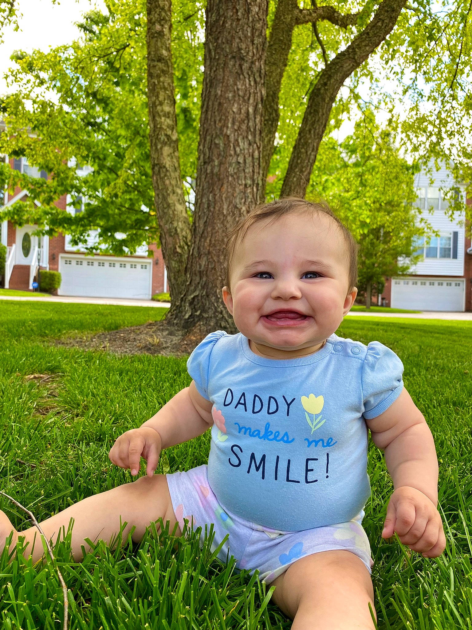 Octavia is registered to the contest to win money with this photo: baby, baby_toddler_clothing, eye, fun, grass, green, happy, joy, leaf, leisure, people_in_nature, person, plant, skin, smile, summer, sunlight, t_shirt, toddler, tree