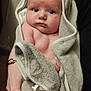 Braxton is registered to the contest to win money with this photo: baby, towel, hooded_towel, infant, child, person, hand, indoor, skin, face, eyes, curious, cute, soft_texture, blanket, newborn, holding, clothing, nap_time, warm