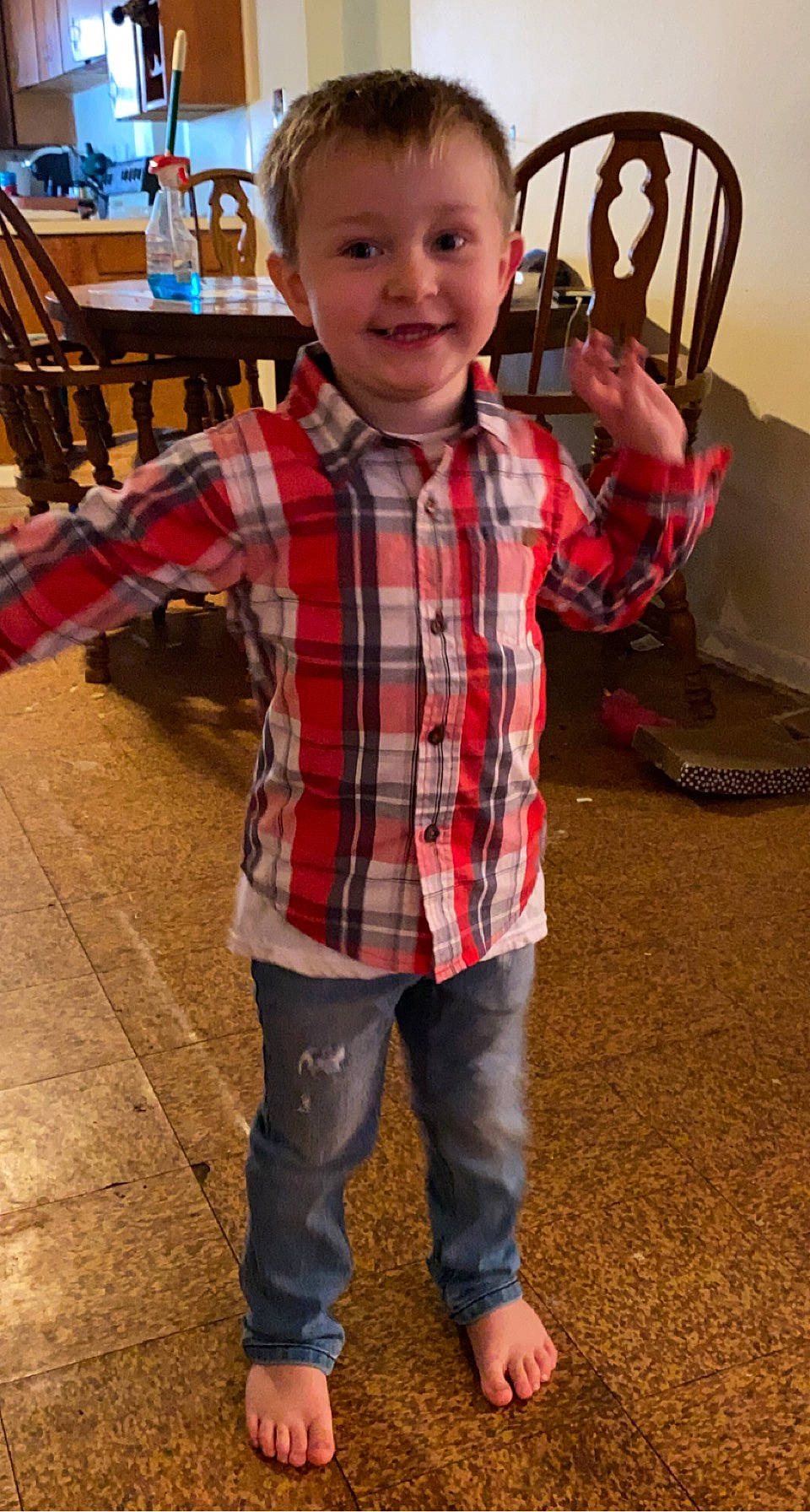 Allen is registered to the contest to win money with this photo: automotive_tire, chair, child, denim, dress_shirt, eye, flooring, fun, happy, joy, pattern, people, person, plaid, plant, sleeve, smile, t_shirt, tartan, textile