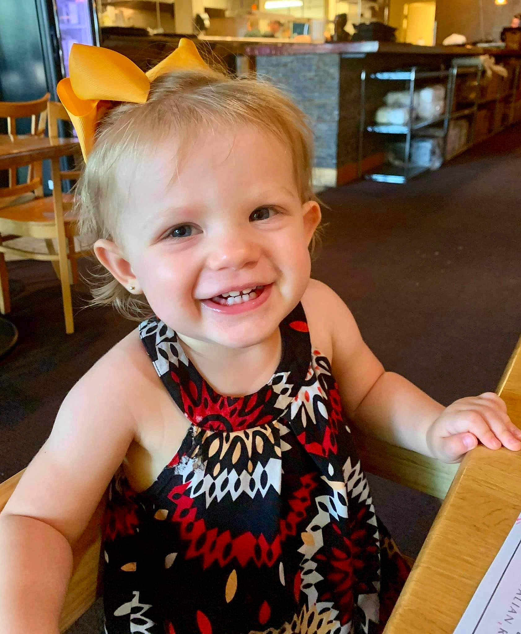 Lorelai is registered to the contest to win money with this photo: baby, child, dress, ear, eye, face, facial_expression, fashion_accessory, happy, head, human_body, iris, joy, neck, organ, person, skin, smile, toddler, tooth