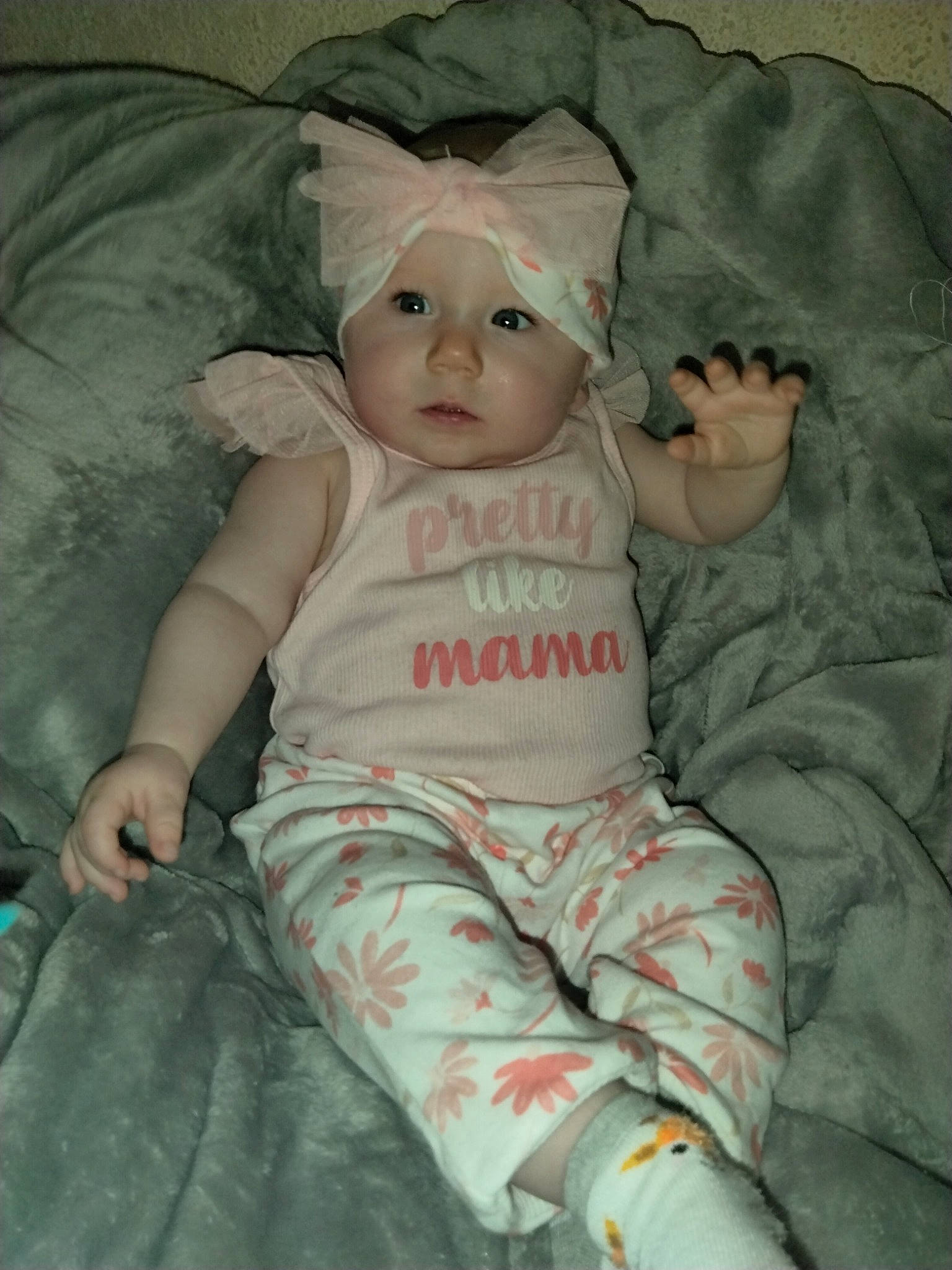 Willow is registered to the contest to win money with this photo: baby, baby_products, baby_safety, baby_toddler_clothing, cheek, child, comfort, eye, grass, hat, headwear, linens, pattern, person, pink, room, sitting, skin, sleeve, textile