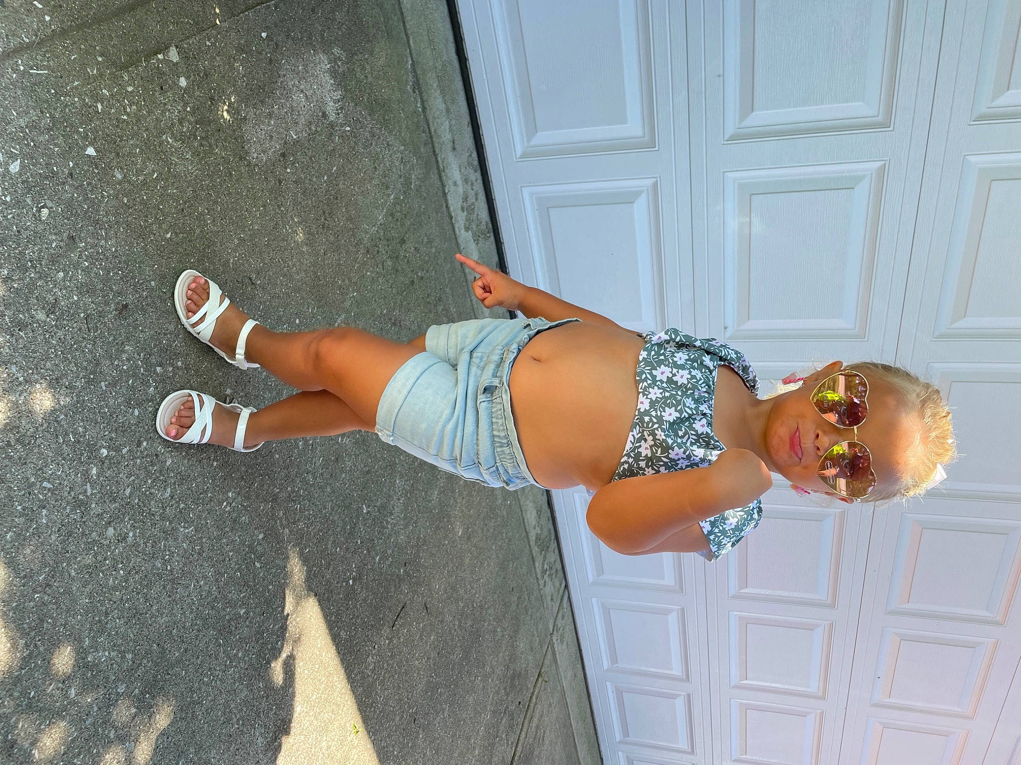 Kinzlee is registered to the contest to win money with this photo: abdomen, blond, calf, elbow, electric_blue, fun, glasses, human_leg, joint, knee, leg, pattern, person, sandal, stomach, sunglasses, thigh, trunk, waist, wall
