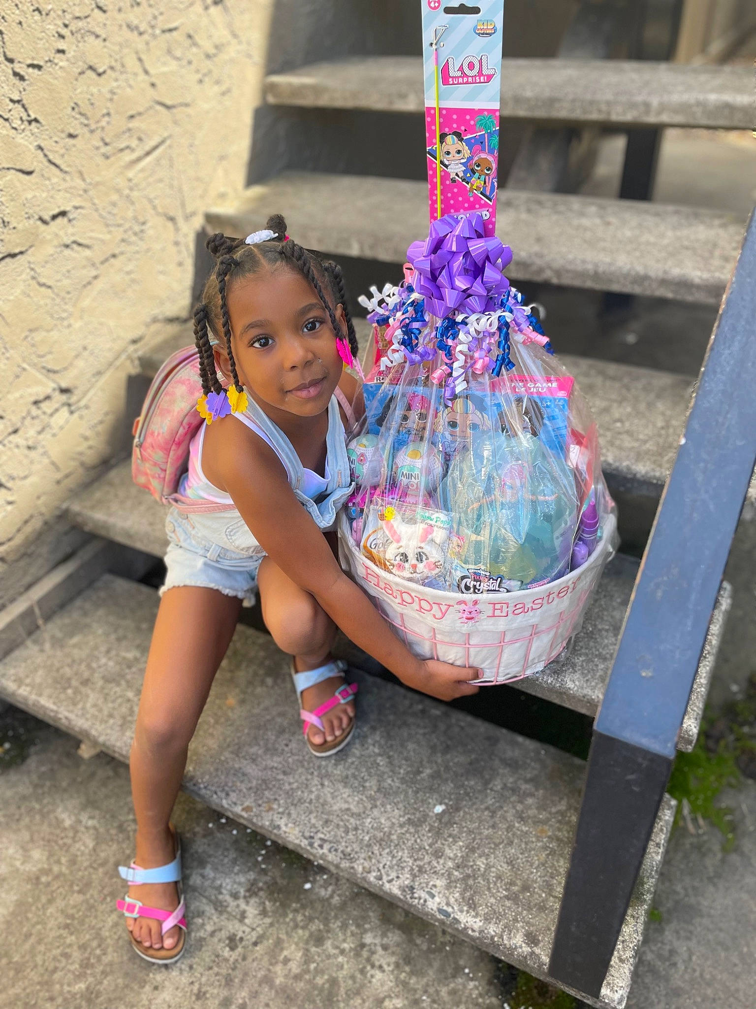 Ah Stori is registered to the contest to win money with this photo: child, easter, electric_blue, fashion_accessory, footwear, fun, grass, happy, human_leg, joy, leisure, magenta, person, pink, recreation, sandal, shoe, shorts, sitting, sneakers