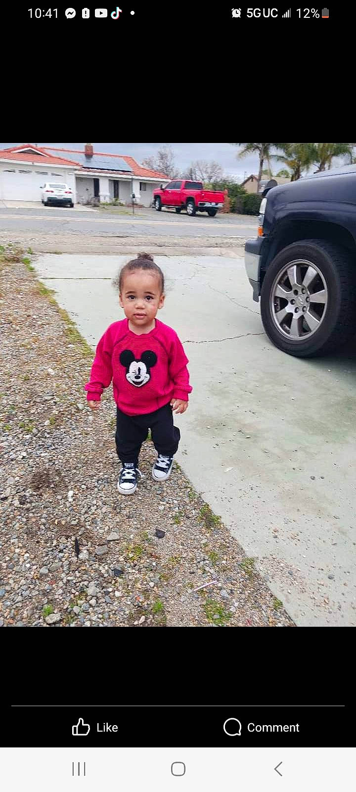 Destin is registered to the contest to win money with this photo: asphalt, automotive_exterior, automotive_tire, bumper, car, child, family_car, grass, motor_vehicle, person, road, road_surface, sidewalk, soil, tints_and_shades, tire, toddler, vehicle, vehicle_door, walking