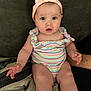 Allivia joined the competition — help win amazing prizes! baby, child, infant, sitting, romper, headband, pink, pastel, rainbow, couch, indoor, soft, curious, wide_eyes, chubby_cheeks, person, cute, portrait, hand, furniture