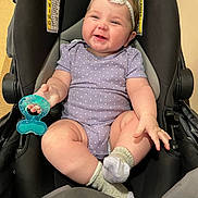 Allivia is registered to the contest to win money with this photo: baby, infant, smile, headband, purple_onesie, polka_dots, teething_toy, stroller, socks, cute, chubby, happy, child, indoor, person, seat, black, toy, comfort, joy