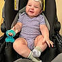 baby, infant, smile, headband, purple_onesie, polka_dots, teething_toy, stroller, socks, cute, chubby, happy, child, indoor, person, seat, black, toy, comfort, joy