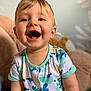 toddler, child, smiling, happy, onesie, colorful_clothing, indoor, plush_toy, soft_toy, face, blue_wall, short_hair, cute, baby, person, portrait, closeup, joyful, playful, light