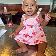 Jai-Lyanna joined the competition — help win amazing prizes! baby, bow, bracelet, child, face, furniture, glass, happy, headband, indoors, infant, lobster_pattern, photography, pink_dress, portrait, restaurant, sitting, smiling, table, wood_paneling
