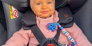 Eloa participe au concours pour gagner de l'argent avec cette photo : baby, child, car_seat, pink_clothing, headband, pacifier, car_interior, smiling, sitting, safety_harness, toy, cute, infant, seatbelt, happy, indoors, person, accessory, clothing, portrait