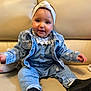 baby, black_shoes, child, clothing, couch, cozy, cute, denim_jacket, denim_pants, happy, headband, indoor, infant, lace_collar, person, portrait, sitting, smiling, white_headband, young_child
