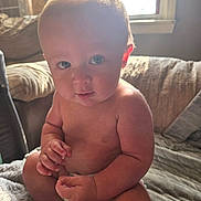 Brodi joined the competition — help win amazing prizes! baby, blanket, child, couch, curious, cute, diaper, face, fingers, hand, home, indoor, infant, natural_light, plump, portrait, sitting, skin, soft, window