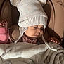baby, sleeping, hat, knitted_hat, bear_ears, blanket, stroller, bottle, infant, child, cute, cozy, pink_clothing, soft, warm, resting, indoors, peaceful, face, portrait