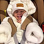 baby, child, car_seat, white_clothing, hat, pom_poms, smile, happy, infant, cute, straps, seatbelt, warm_clothing, portrait, face, winter_wear, cozy, small_child, infant_clothing, baby_girl