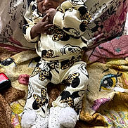 Ocean is registered to the contest to win money with this photo: baby, child, infant, mickey_mouse, clothing, blanket, pillow, patterned, cute, cozy, indoors, face, hands, feet, shoes, white, black, yellow, pink, smiling