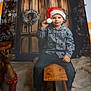 Benjamin participe au concours pour gagner de l'argent avec cette photo : child, christmas, christmas_wreath, cozy, decorations, festive, holiday, holiday_decor, indoor, joyful, pajamas, playful, pom_pom, reindeer_decoration, santa_hat, smiling, soft_lighting, winter_theme, wooden_door, wooden_stool