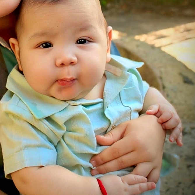 Prometheus is registered to the contest to win money with this photo: baby, bracelet, casual, child, clothing, cute, expression, face, hands, happy, holding, infant, nature, outdoor, person, portrait, sitting, skin, smiling, young