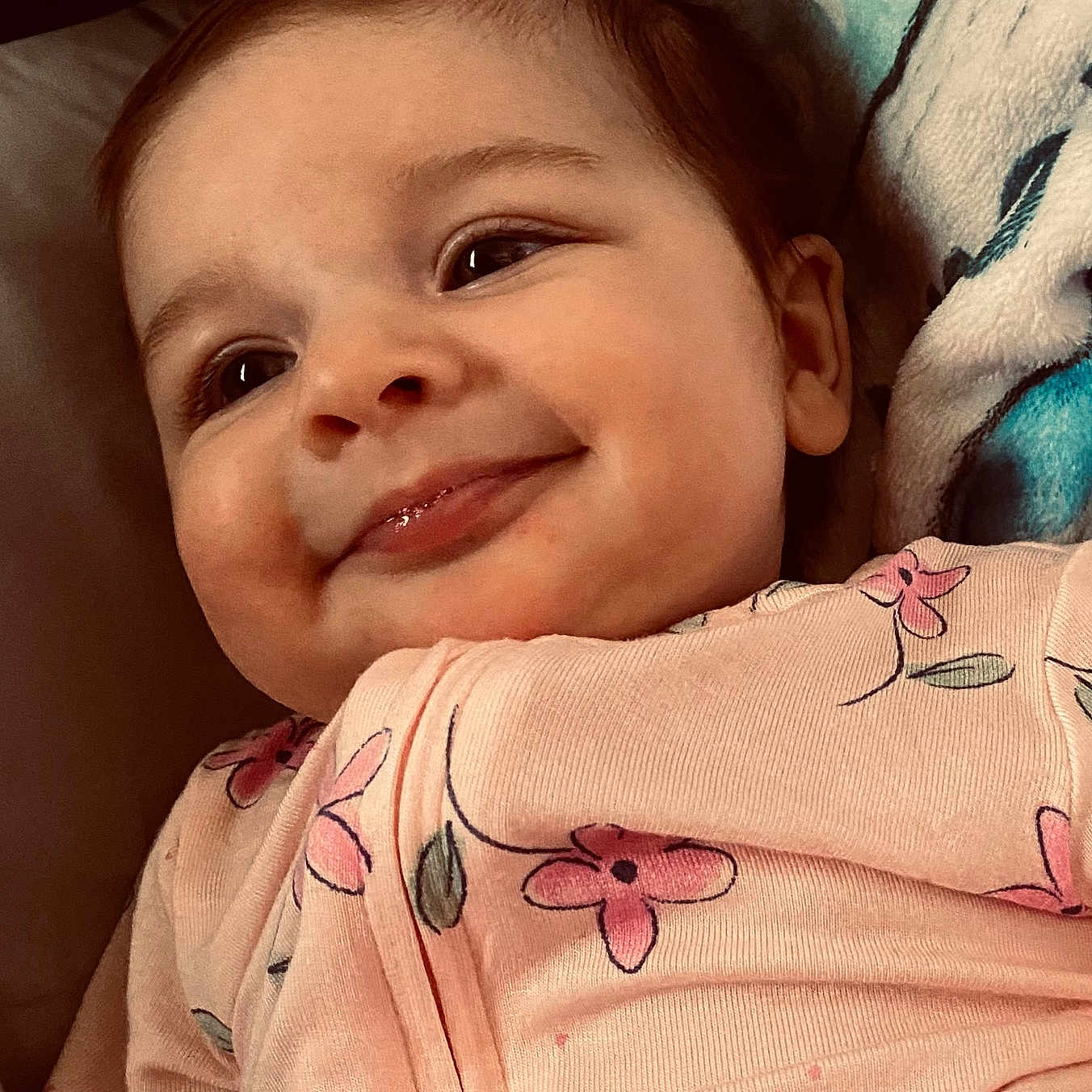 Aurora joined the competition — help win amazing prizes! baby, blanket, cheeks, child, closeup, cozy, cute, eyelashes, face, floral_pattern, happy, home, infant, onesie, person, portrait, skin, sleepwear, smiling, soft