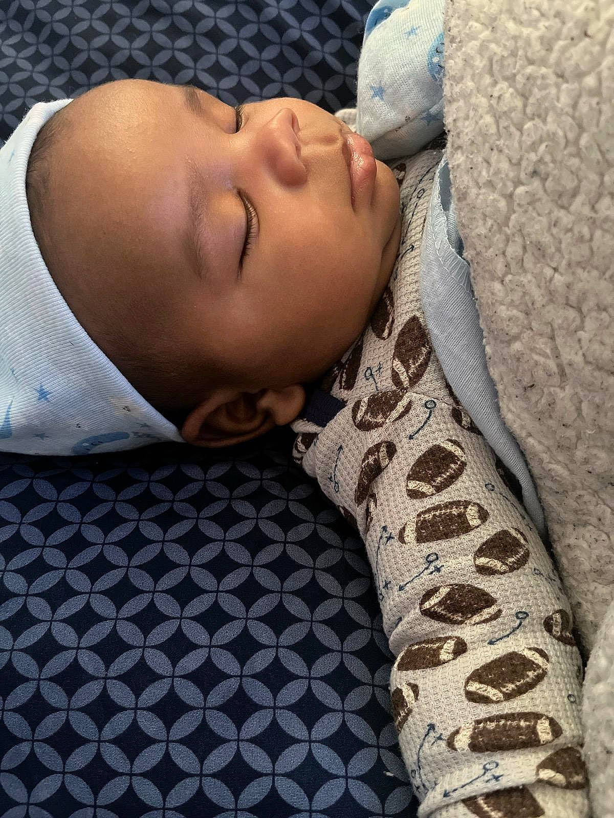 Kaden is registered to the contest to win money with this photo: baby, baby_sleeping, bedding, bedtime, child, comfort, couch, fur, glasses, grey, linens, military_camouflage, nap, pattern, person, skin, sleep, sleeve, textile, toddler