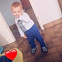 child, clothing, cute, door, doorway, floor, footwear, happy, home, indoor, pants, person, red_heart_emoji, shirt, smiling, sock, standing, tile_floor, toddler, wall