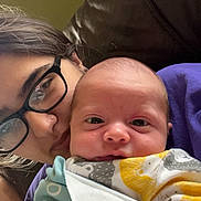 Timothy is registered to the contest to win money with this photo: baby, adult, glasses, blanket, couch, face, person, indoor, closeup, love, family, comfort, portrait, skin, head, young_child, eyewear, resting, casual, warmth