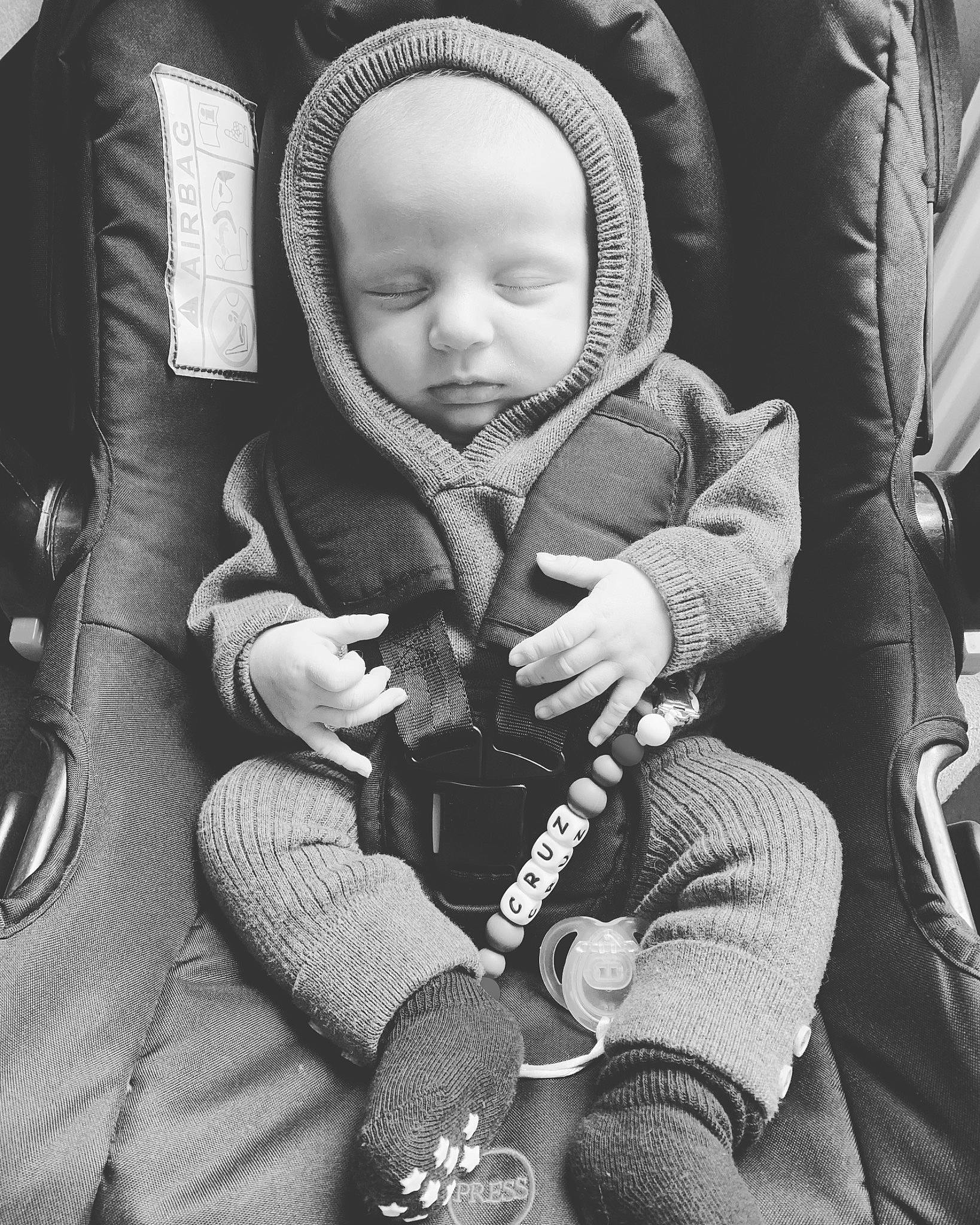 Cruz is registered to the contest to win money with this photo: baby, baby_carriage, baby_products, black, black_and_white, child, comfort, finger, gesture, hand, monochrome, monochrome_photography, person, photograph, product, sitting, skin, snapshot, style, toddler