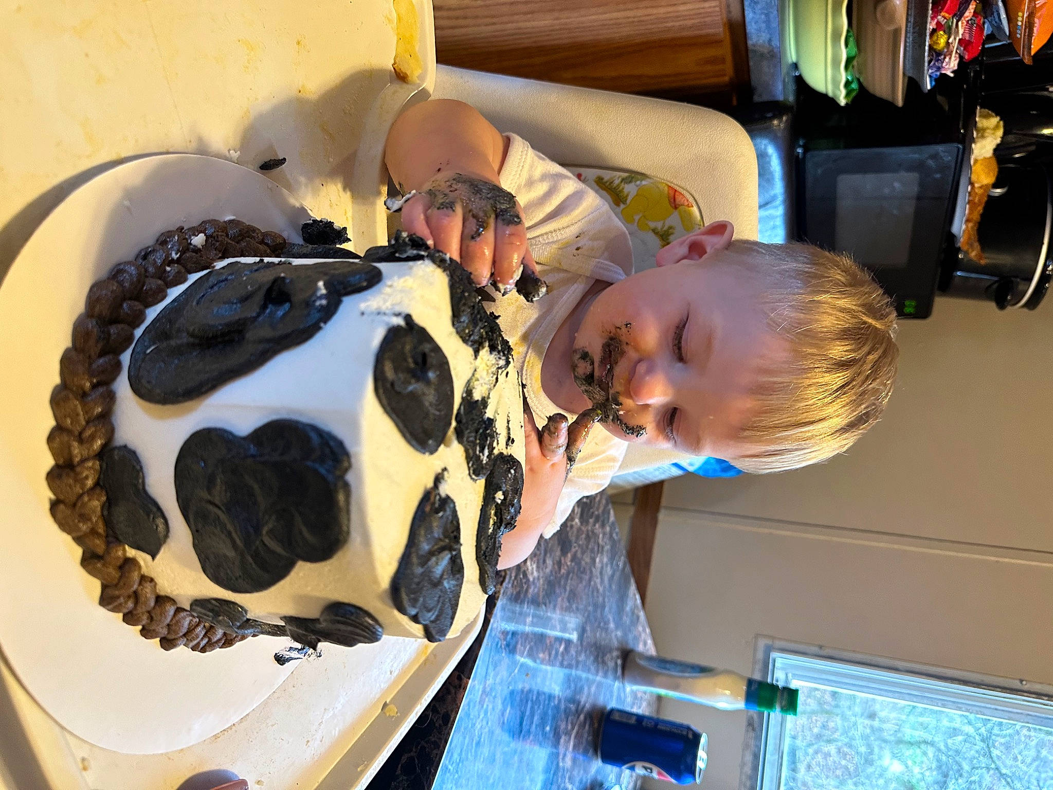 Cole is registered to the contest to win money with this photo: baby, birthday_cake, bone, buttercream, cake, cake_decorating, child, cream, dessert, eyewear, food, fun, hairstyle, icing, leisure, person, personal_protective_equipment, smile, sweetness, t_shirt