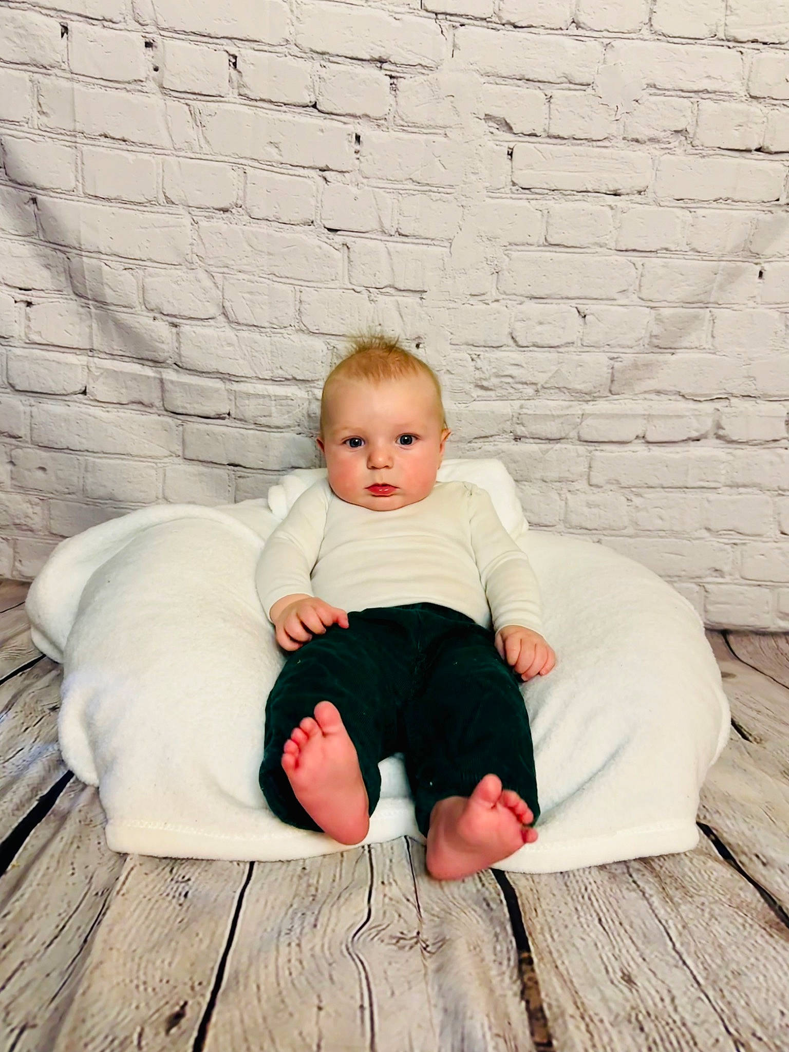 Dustin is registered to the contest to win money with this photo: baby, baby_toddler_clothing, brick, brickwork, comfort, flash_photography, floor, flooring, foot, grass, happy, hardwood, human_body, human_leg, knee, leg, person, sitting, sleeve, toddler