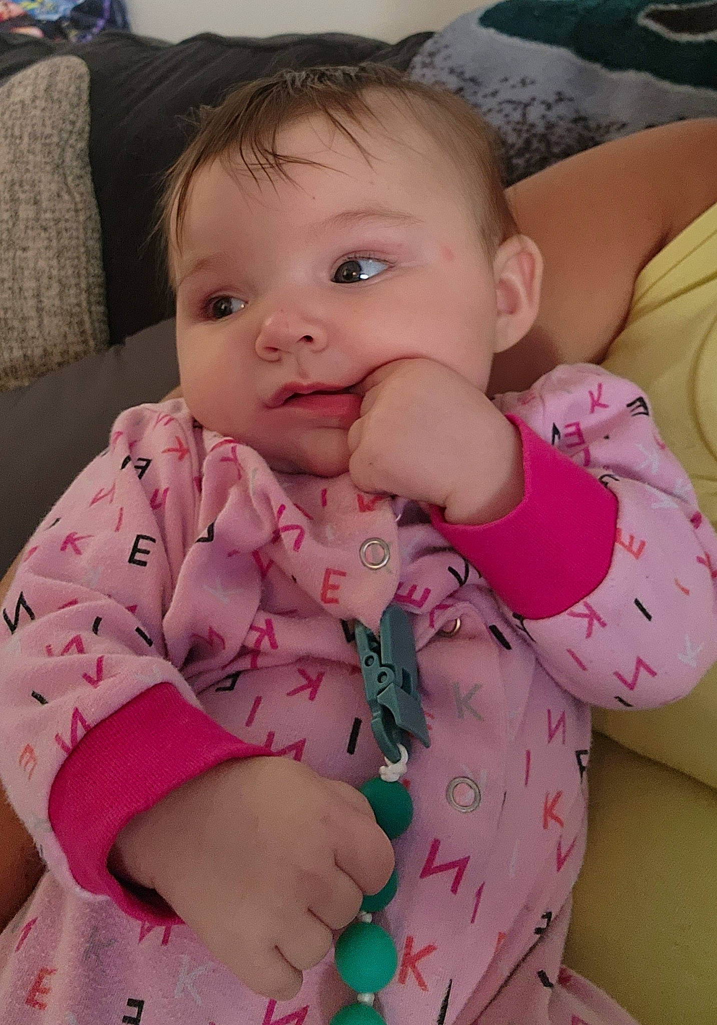 Abigail is registered to the contest to win money with this photo: arm, baby, baby_toddler_clothing, cheek, child, chin, collar, comfort, eye, finger, head, iris, lip, mouth, nose, person, pink, product, skin, sleeve