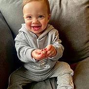 Logan is registered to the contest to win money with this photo: baby, babylaughing, bodypart, clothing, couch, cushion, face, finger, furniture, happy, head, homedecor, jeans, laughing, pants, person, photography, portrait, sitting, smile