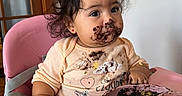 Avery joined the competition — help win amazing prizes! baby, baby_clothing, child, chocolate, dark_hair, earring, feeding, food, food_tray, high_chair, home, indoor, mealtime, messy_face, pink_chair, portrait, scrambled_eggs, sitting, smiling, toddler