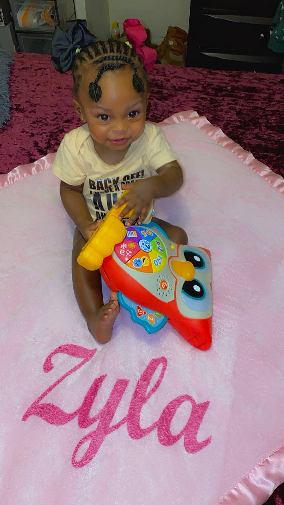 Zyla joined the competition — help win amazing prizes! baby, ball, bed, bedroom, clothing, cushion, face, football, furniture, head, homedecor, indoors, person, photography, portrait, room, sitting, t_shirt, text, toy