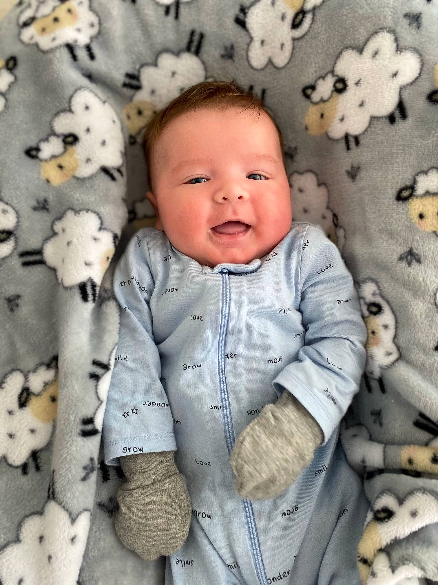 Dustin is registered to the contest to win money with this photo: baby, baby_toddler_clothing, cheek, child, collar, comfort, eye, grey, happy, linens, outerwear, pattern, person, skin, sleeve, smile, textile, toddler, white, wood