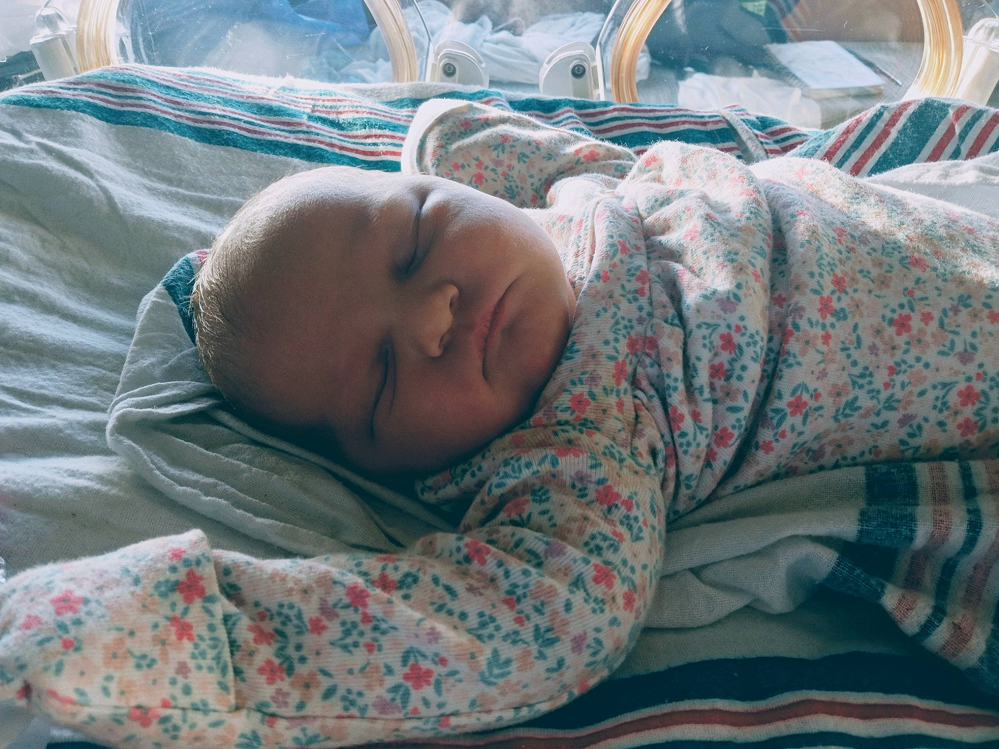 Korey is registered to the contest to win money with this photo: baby, bed_sheet, bedding, bedtime, blanket, child, comfort, grass, head, linens, nap, pattern, person, room, sleep, sleeve, toddler