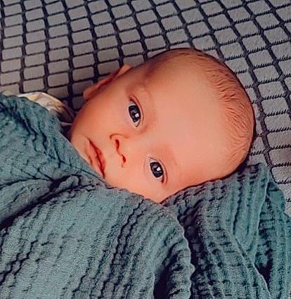 Louie is registered to the contest to win money with this photo: baby, baby_toddler_clothing, cheek, comfort, eyebrow, eyelash, face, forehead, hair, headgear, human_body, iris, lip, mouth, nose, person, skin, sleeve, textile, toddler