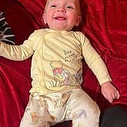 Dalton joined the competition — help win amazing prizes! apparel, baby, blanket, child, clothing, cozy, cute, face, happy, human, indoors, infant, lying_down, pajamas, person, portrait, red, smiling, winnie_the_pooh, young_child