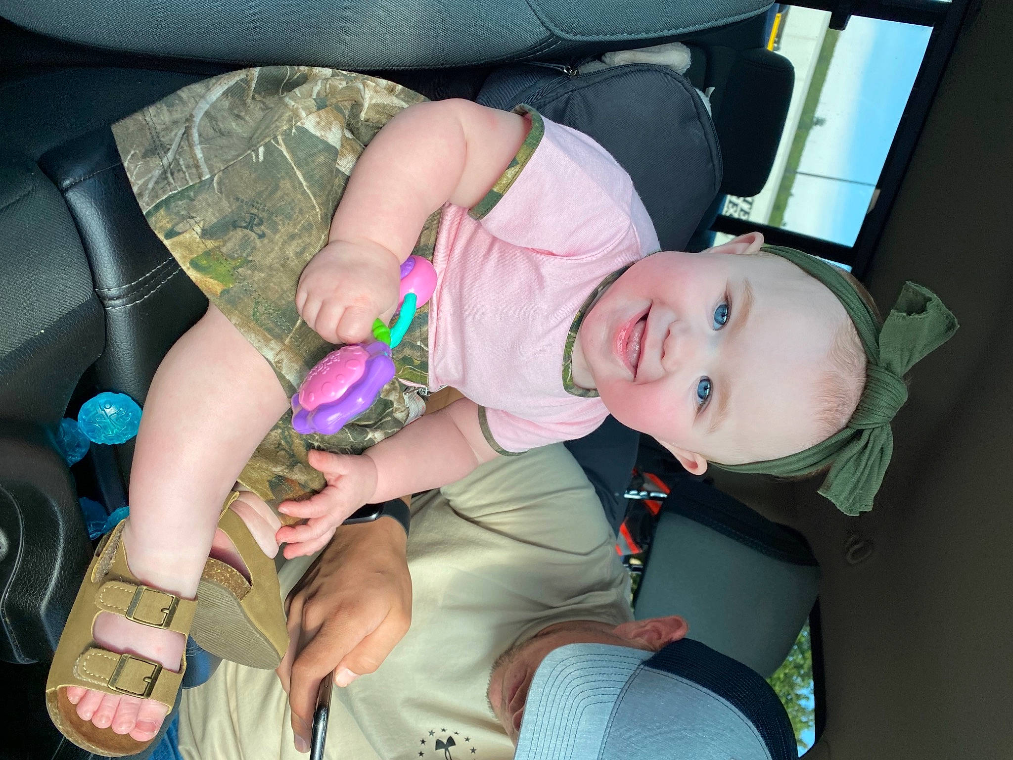 Braelyn is registered to the contest to win money with this photo: auto_part, baby, baby_carriage, car_seat, child, comfort, cool, facial_expression, finger, fun, hand, joy, lap, leg, mouth, people, person, seat_belt, snapshot, thigh