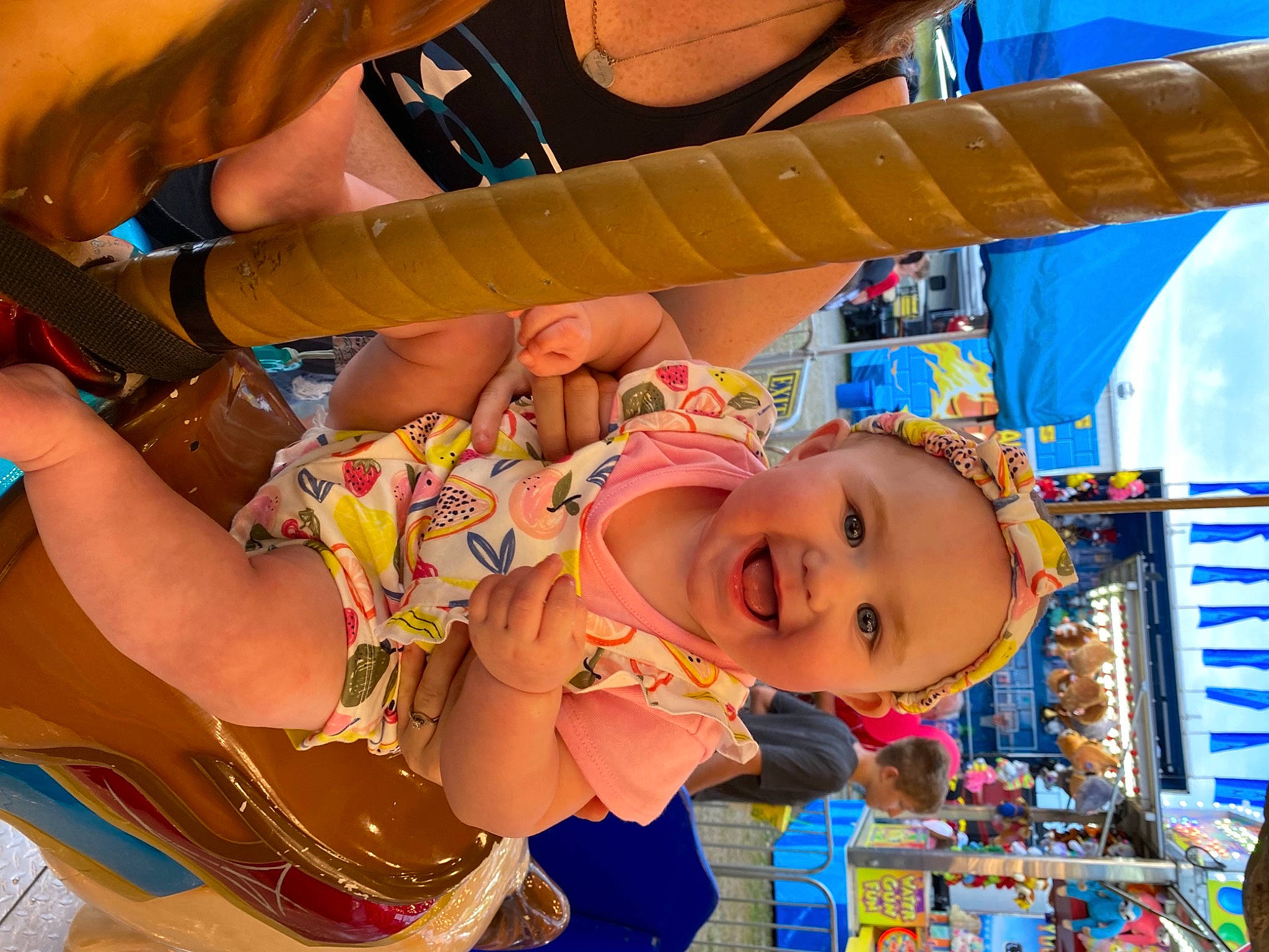 Braelyn is registered to the contest to win money with this photo: amusement_park, amusement_ride, blue, child, event, fun, happy, hat, human_leg, joy, leisure, mouth, orange, person, recreation, shorts, smile, snapshot, summer, thigh