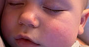 Carson is registered to the contest to win money with this photo: baby, sleeping, face, infant, cozy, onesie, pattern, closeup, peaceful, skin, head, cheek, eyelashes, soft, child, newborn, rest, comfort, indoors, human