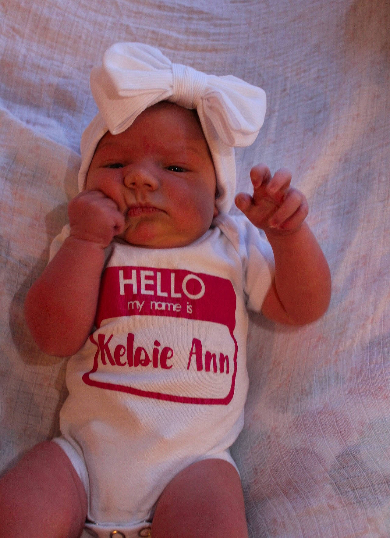 Kelsie is registered to the contest to win money with this photo: baby, baby_toddler_clothing, cheek, child, face, facial_expression, finger, happy, human_body, leg, mouth, nail, person, pink, product, skin, sleeve, textile, thigh, thumb