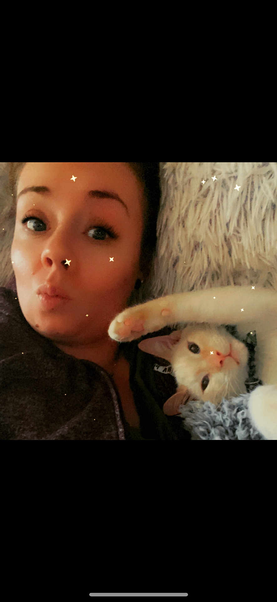 Bear is registered to the contest to win money with this photo: person, cat, face, paw, blanket, fur, cozy, indoor, cute, relaxed, portrait, animal, pet, snuggle, expression, closeup, whiskers, feline, playful, star_effects