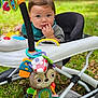 Lucas joined the competition — help win amazing prizes! baby, walker, toy, outdoor, grass, child, infant, face, cute, colorful, playtime, nature, green, sitting, curious, young_child, clothing, hand, expression, seat