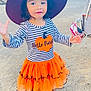 accessories, bag, child, clothing, costume, dress, face, female, footwear, girl, handbag, hat, head, outdoors, person, photography, portrait, shoe, skirt, sunhat