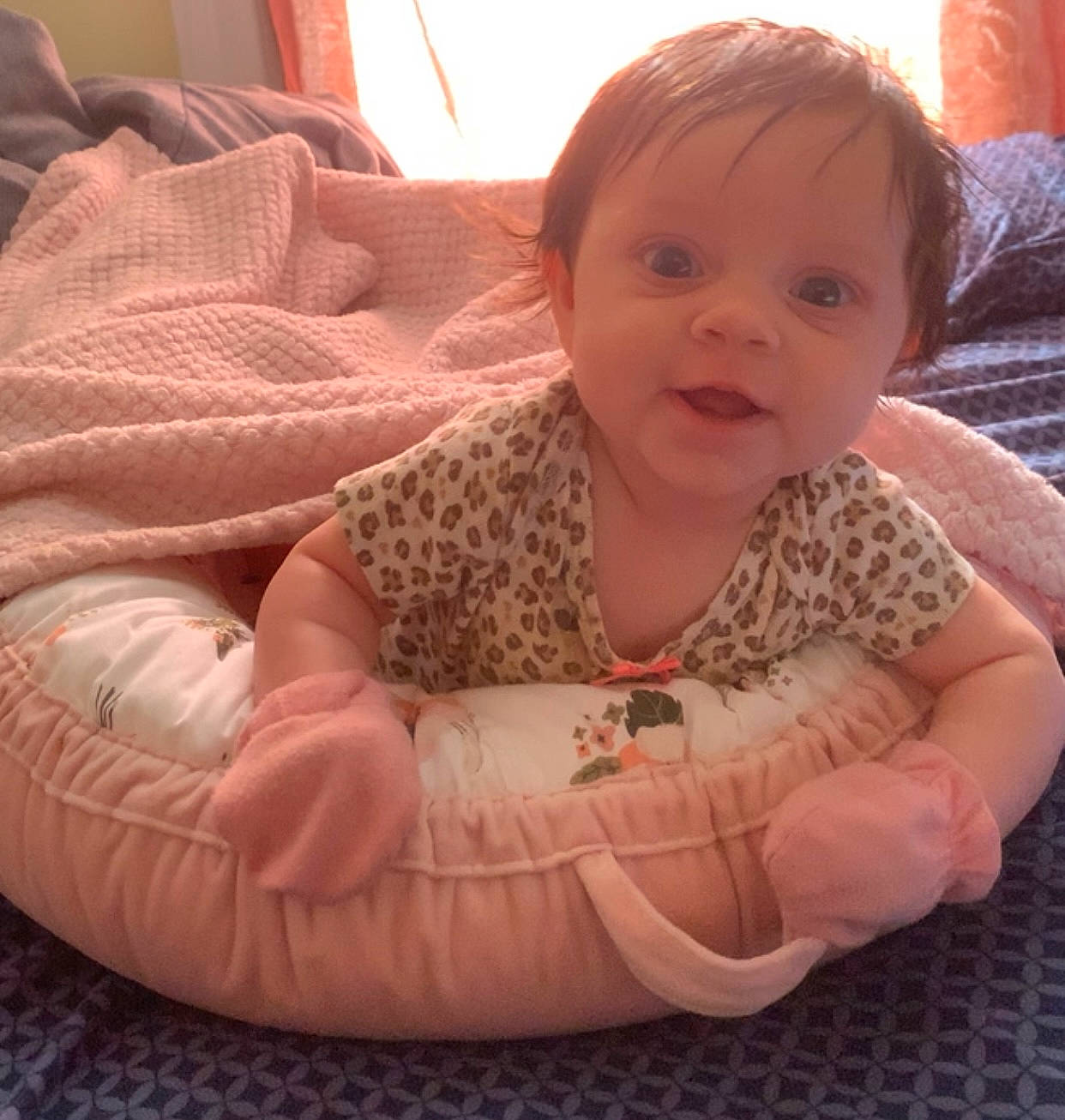 Fallon is registered to the contest to win money with this photo: arm, baby, baby_toddler_clothing, cheek, chin, comfort, couch, finger, fun, happy, head, iris, mouth, nose, person, pink, skin, sleeve, smile, thumb