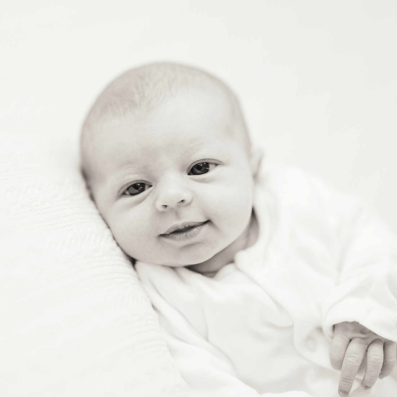 Daisy is registered to the contest to win money with this photo: baby, bodypart, face, finger, hand, happy, head, newborn, person, photography, portrait, smile