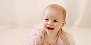 Freya is registered to the contest to win money with this photo: baby, child, crawling, smiling, pink_dress, long_sleeves, floor, carpet, indoor, portrait, cute, happy, young_child, infant, person, toddler, light_skin, blonde_hair, soft_lighting, neutral_background