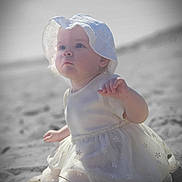 Freya joined the competition — help win amazing prizes! baby, child, infant, beach, sand, dress, hat, sun_hat, outdoor, portrait, cute, sitting, white_clothing, young_child, soft_light, curious, nature, daytime, small_hand, face