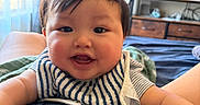 Ezra joined the competition — help win amazing prizes! baby, child, infant, smiling, happy, portrait, indoors, bedroom, bib, striped_clothing, short_hair, face, eyes, mouth, arms, television, furniture, curtains, bed, photography